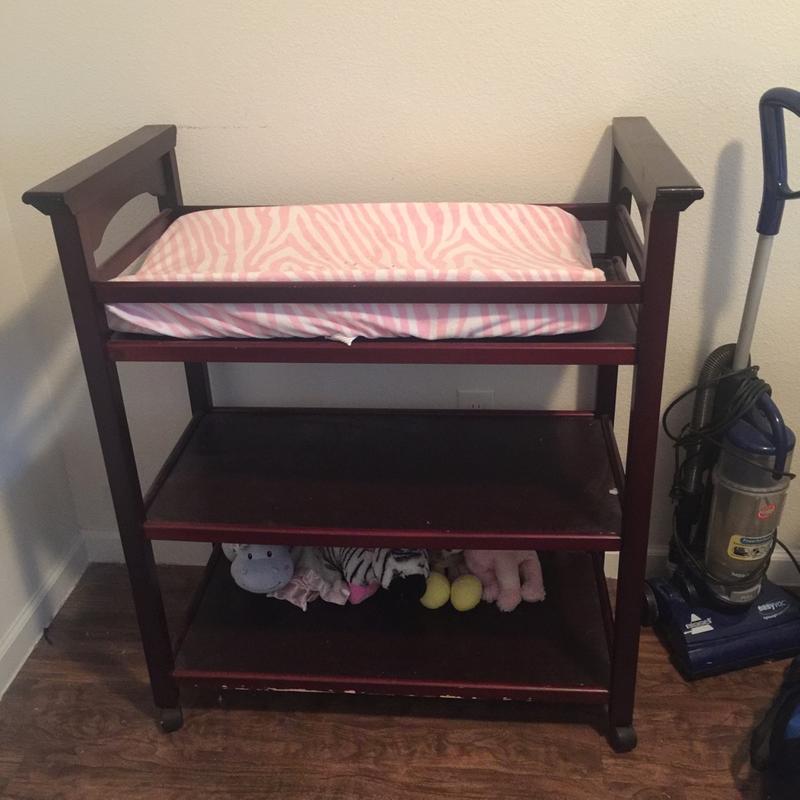 Wooden changing table with wheels. Comes with baby pad. for sale in