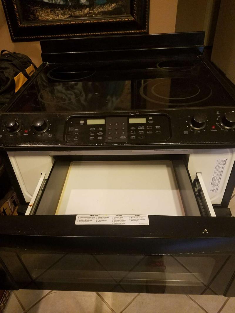 Black slide in stove, full size oven and has the drawer slide out