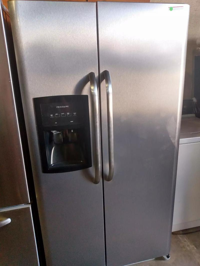 Frigidaire side by side stainless steel refrigerator with warranty for