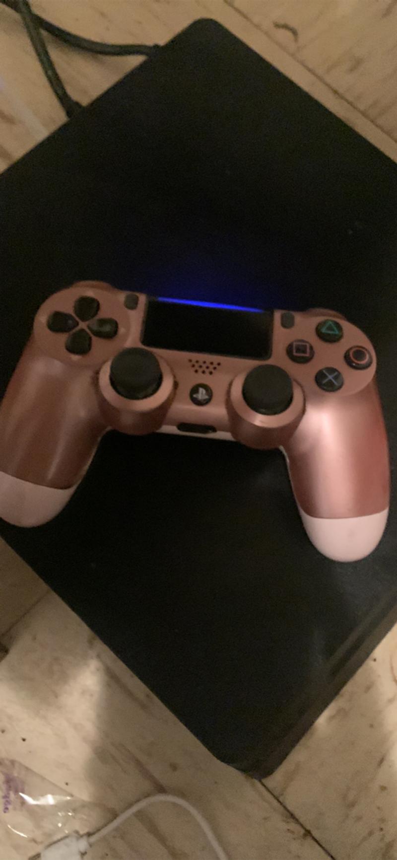 PlayStation 4 slim with games installed and wires with controller for