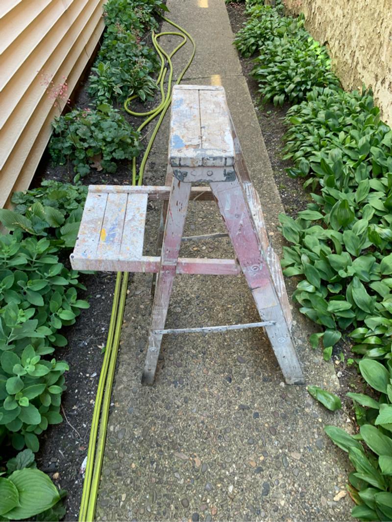 Old vintage wooden step ladder with paint splatters, lynn ladder