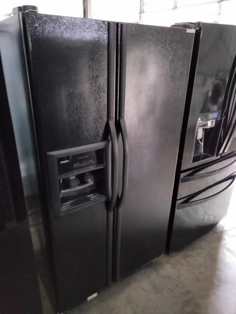 Kenmore refrigerator side by side color black for sale in Houston, TX